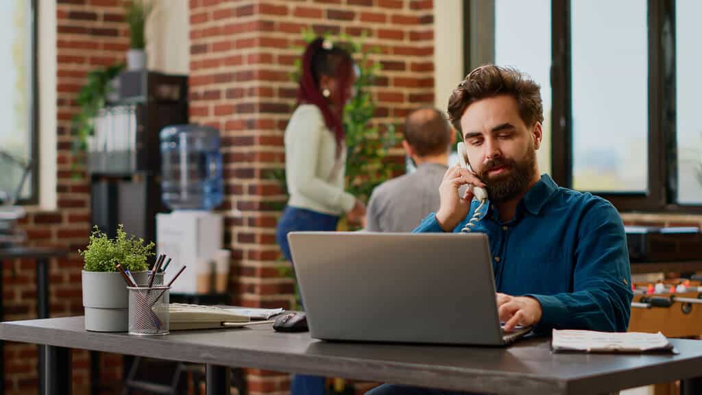 An employee taking a client call.