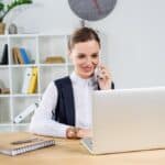 A young businesswoman taking a customer call while at the office.