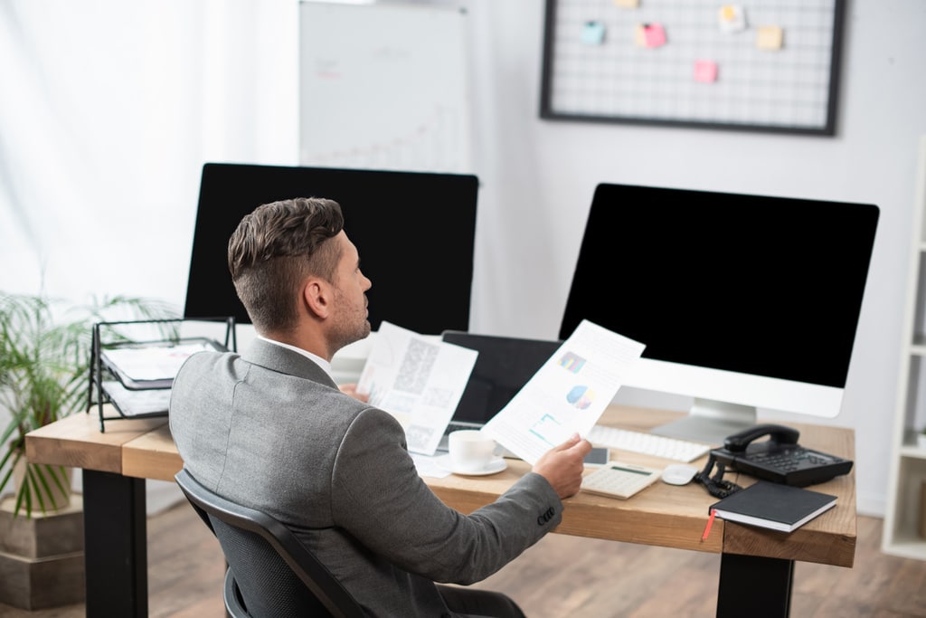 A business director in an office with a landline phone system