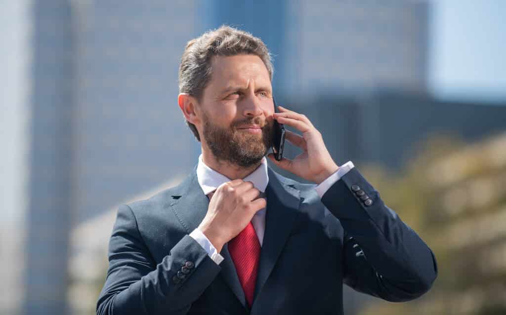 A business professional taking a call on his mobile phone.